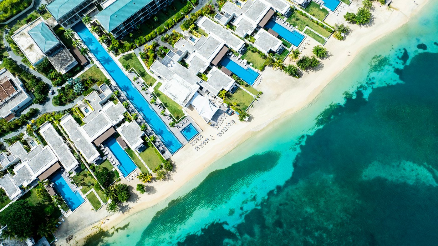 Aerial view of beachfront villas with private pools