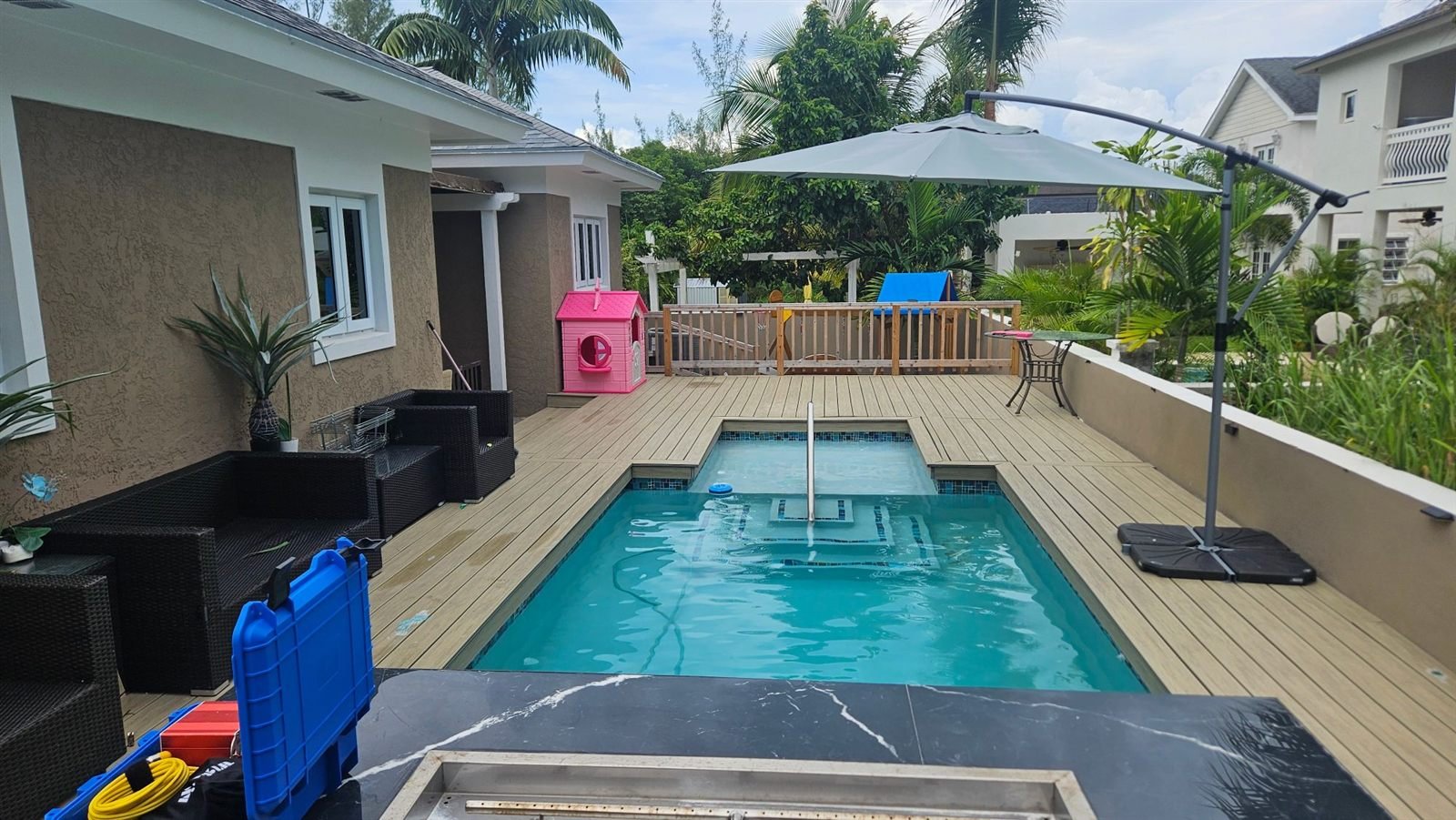 Backyard plunge pool and deck with leak detection equipment cases
