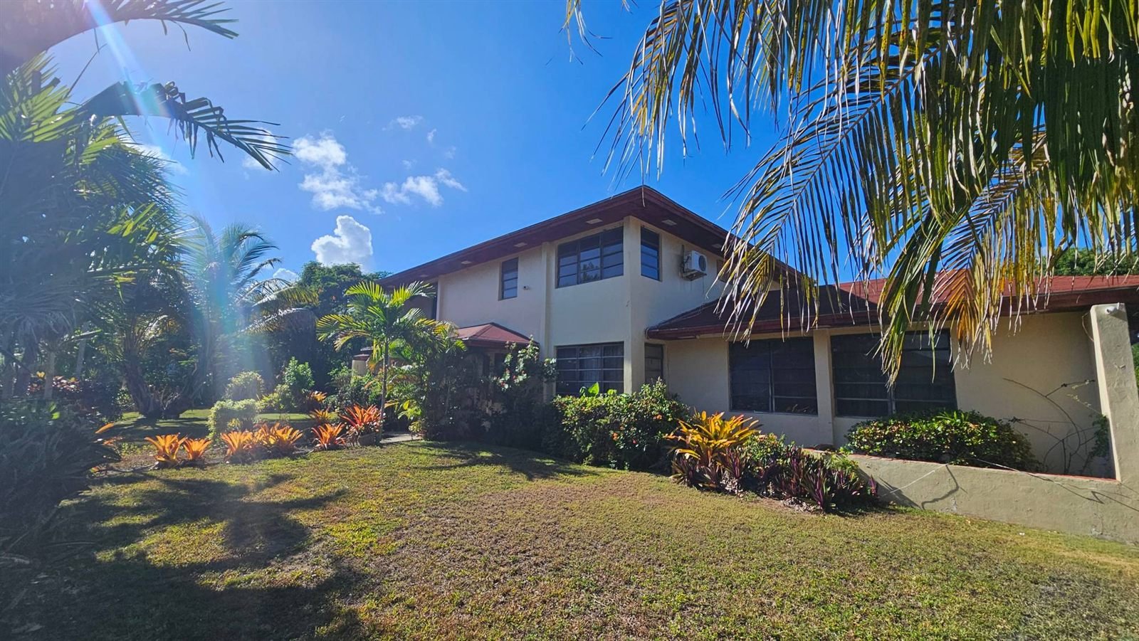Two-storey home with a tropical garden