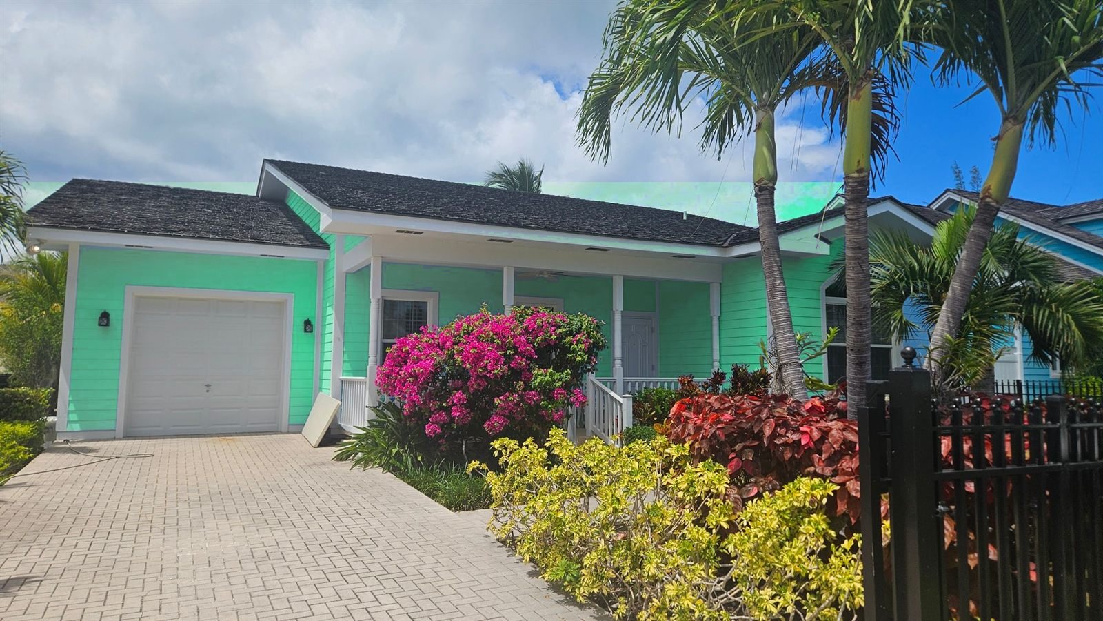 Island cottage with a front porch and bougainvillea