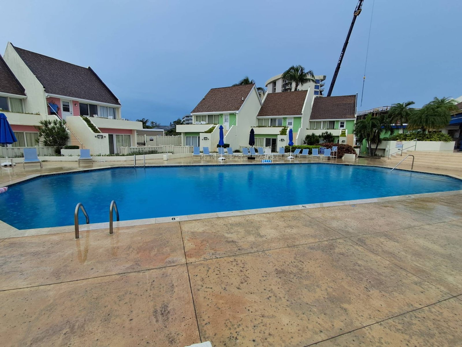Community pool surrounded by pastel townhouses