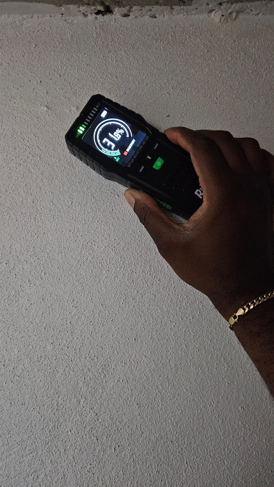 Moisture meter reading on a masonry wall
